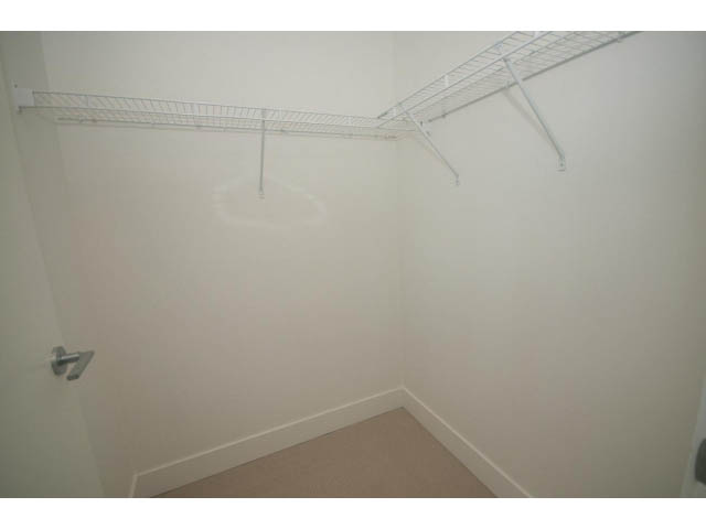 Empty closet with white wire shelving and beige carpet. - 2401 - 1550 Fern Street, North Vancouver
