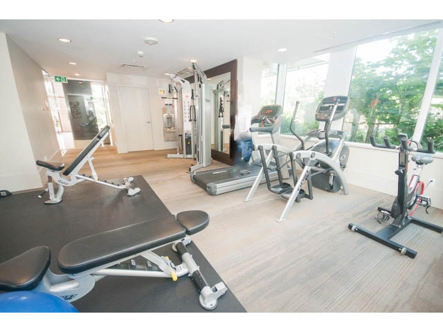 Bright and spacious gym with hardwood floors, cardio machines, and natural light. - 2401 - 1550 Fern Street, North Vancouver