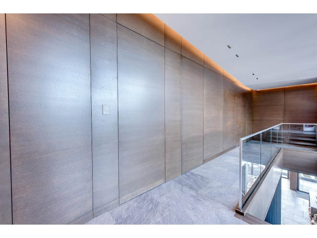 Modern living room with sleek wood paneling and glass railings. - Address WITHHELD, Burnaby