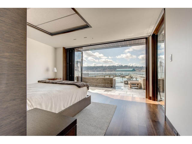 Spacious bedroom with hardwood floors and a stunning city view. - Address WITHHELD, Burnaby