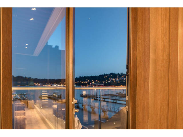 Bright living room with city view and modern wood paneling. - Address WITHHELD, Burnaby