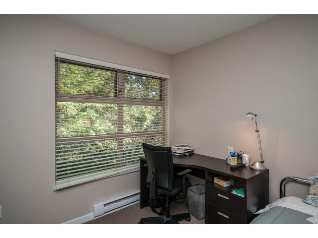 Bright bedroom with desk, chair, and window view of trees. - 17 - 3750 Edgemont Boulevard, North Vancouver