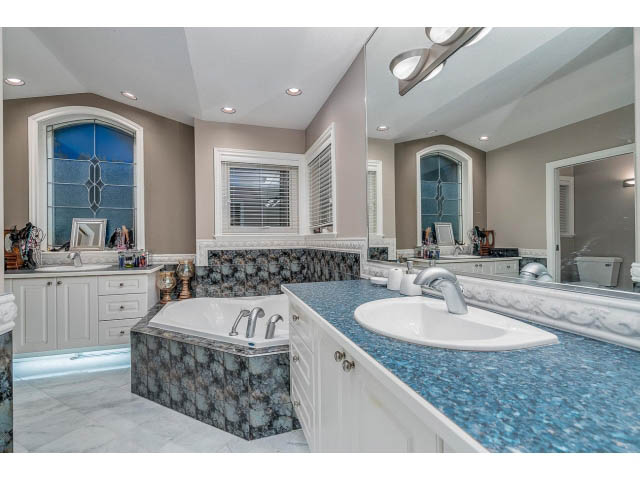 Spacious bathroom with marble countertops and large mirrors. - 4287 Madeley Rd, North Vancouver
