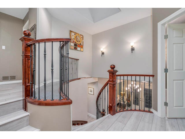 Stunning entryway with elegant curved staircase and hardwood floors. - 4287 Madeley Rd, North Vancouver