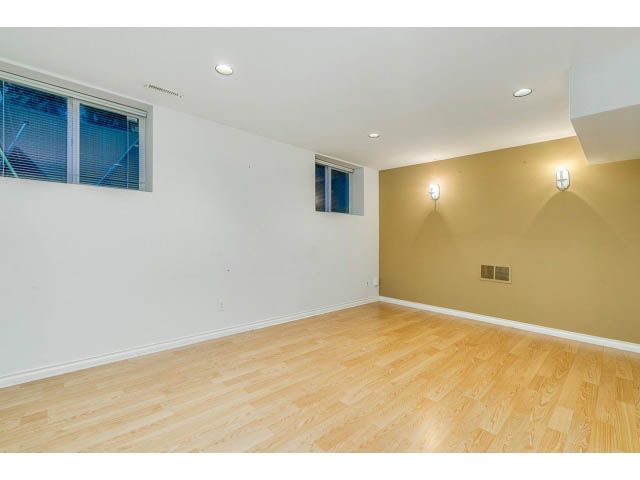 Bright open den with hardwood floors and wall sconces. - 4287 Madeley Rd, North Vancouver