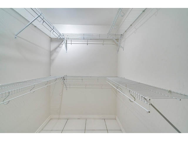 Empty storage room with wire shelving and white walls. - 4287 Madeley Rd, North Vancouver