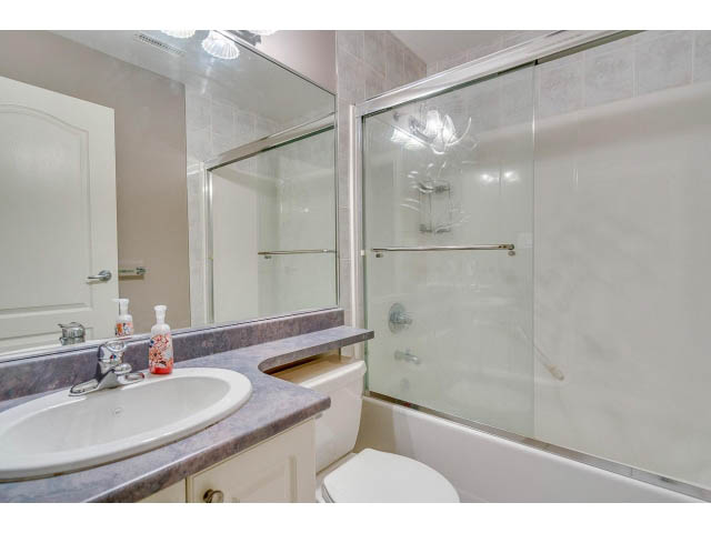 Bathroom with marble countertops and a glass shower, clean and modern. - 4287 Madeley Rd, North Vancouver