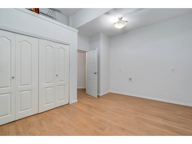 Bright entryway with white closet doors and hardwood floors. - 4287 Madeley Rd, North Vancouver
