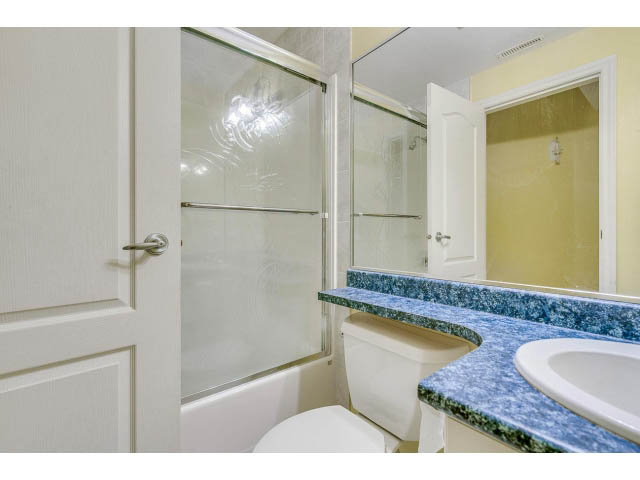 Furnished bathroom with blue granite countertops and a glass shower. - 4287 Madeley Rd, North Vancouver