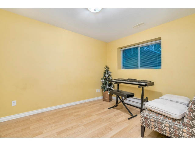 Bright living room with hardwood floors and a large window. - 4287 Madeley Rd, North Vancouver