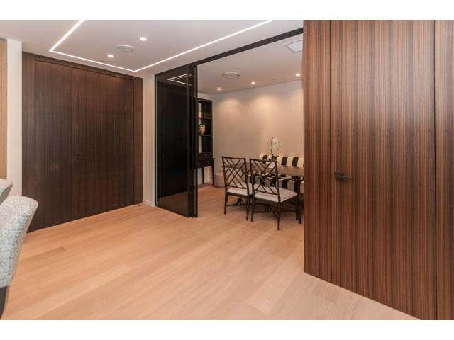 Furnished living room with hardwood floors and modern lighting. - 409 - 1355 Bellevue Ave, West Vancouver