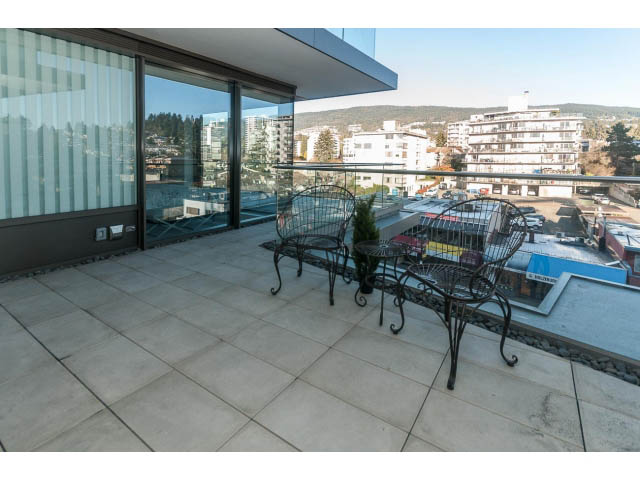 Furnished balcony with outdoor seating and city view. - 409 - 1355 Bellevue Ave, West Vancouver