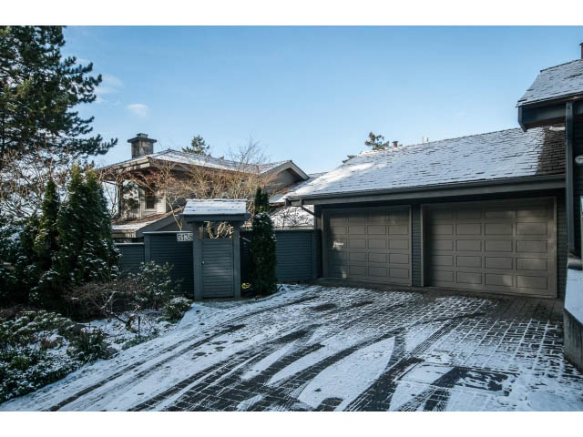 Furnished 3-bedroom + den house with snow-covered roof and driveway, surrounded by evergreen trees. - 5138 Meadfeild Road, West Vancouver