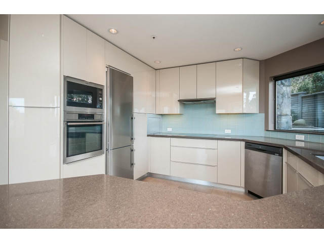Bright kitchen with modern appliances and sleek countertops. - 5138 Meadfeild Road, West Vancouver