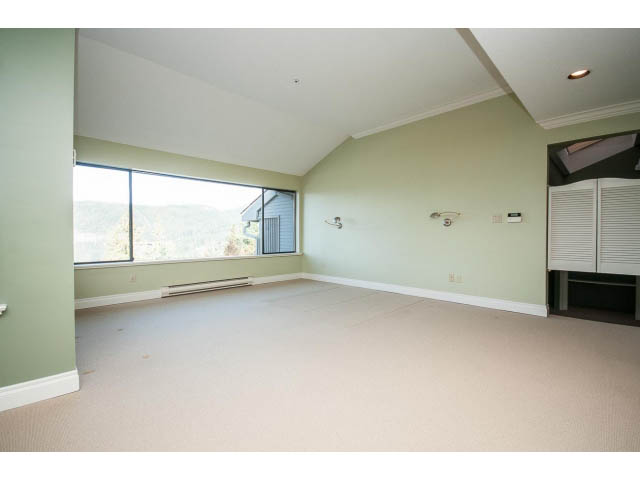 Spacious den with large windows, green walls, and carpeted floor. - 5138 Meadfeild Road, West Vancouver