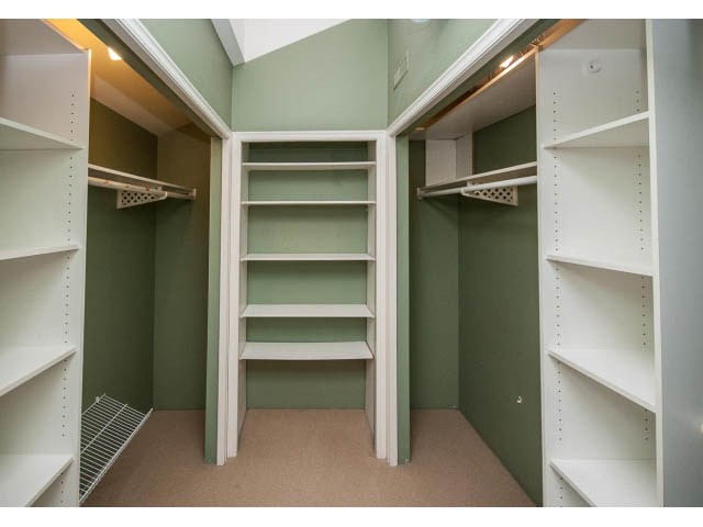 Spacious walk-in closet with white shelving and green walls. - 5138 Meadfeild Road, West Vancouver