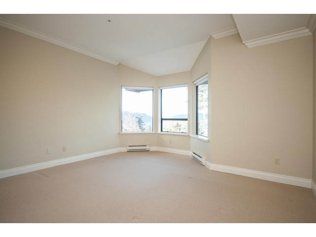 Bright living room with large windows and a city view. - 5138 Meadfeild Road, West Vancouver