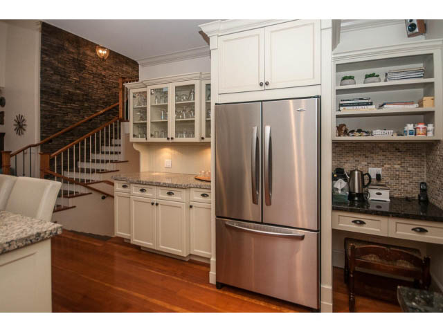 Bright kitchen with stainless steel appliances, granite countertops, and hardwood floors. - 840 16th East St, North Vancouver