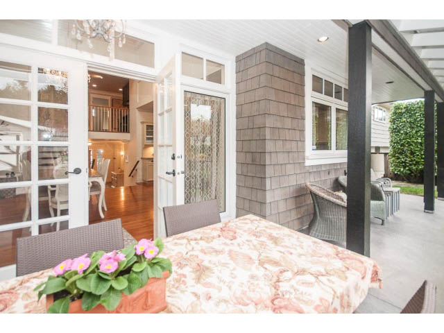 Furnished living room with floral tablecloth and outdoor seating area. - 840 16th East St, North Vancouver