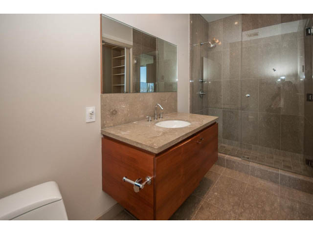 Modern bathroom with wooden vanity and large mirror, showcasing a sleek design. - 2200 - 1169 W Cordova St, Vancouver Downtown