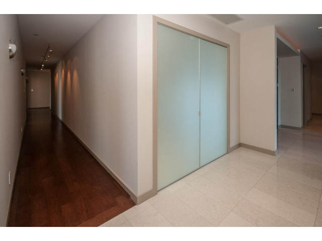 Furnished hallway with hardwood floors and glass sliding doors leading to another room. - 2200 - 1169 W Cordova St, Vancouver Downtown