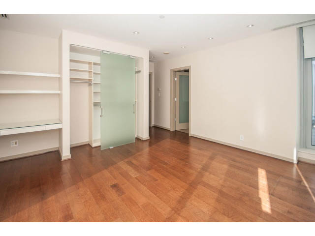 Bright living room with hardwood floors and built-in shelving. - 2200 - 1169 W Cordova St, Vancouver Downtown