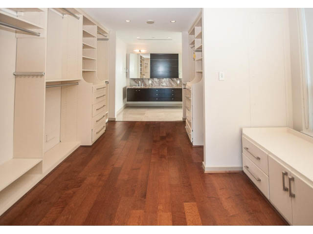 Furnished bedroom with hardwood floors and built-in shelving. - 2200 - 1169 W Cordova St, Vancouver Downtown