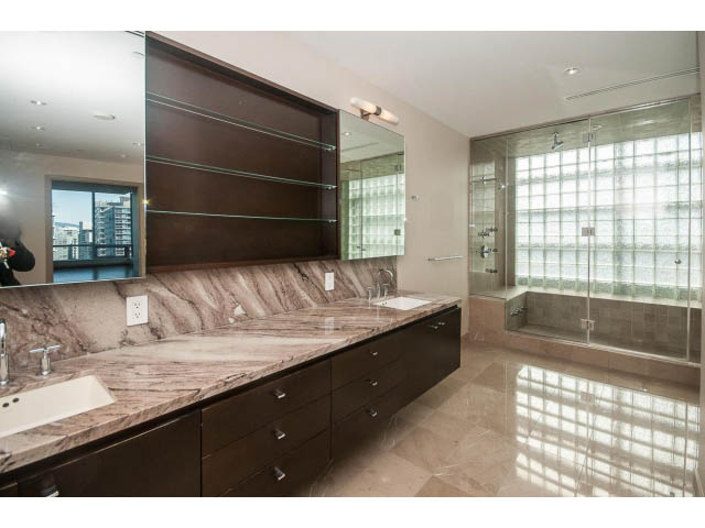 Spacious bathroom with marble countertops and glass block shower, offering a modern and luxurious feel. - 2200 - 1169 W Cordova St, Vancouver Downtown