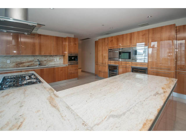 Bright kitchen with granite countertops, stainless steel appliances, and wooden cabinets. - 2200 - 1169 W Cordova St, Vancouver Downtown