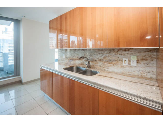 Bright kitchen with granite countertops and wooden cabinets, modern design. - 2200 - 1169 W Cordova St, Vancouver Downtown