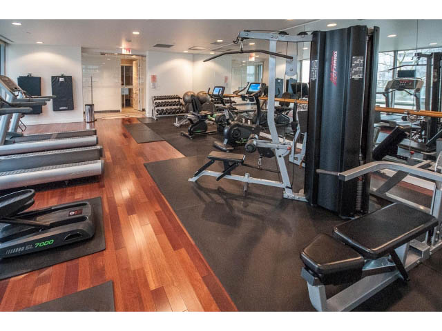 Spacious gym with hardwood floors, cardio machines, and weight equipment. - 2200 - 1169 W Cordova St, Vancouver Downtown