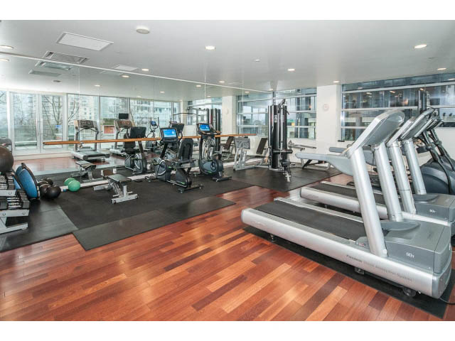 Bright gym with hardwood floors, cardio machines, and city view mirrors. - 2200 - 1169 W Cordova St, Vancouver Downtown