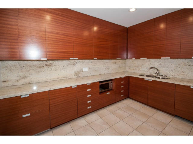 Bright kitchen with modern wood cabinets, granite countertops, and tiled floor. - 2200 - 1169 W Cordova St, Vancouver Downtown