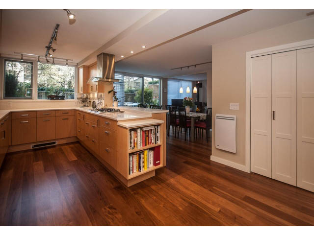 Bright kitchen with wooden floors, open shelving, and city view. - 108 - 456 Moberly Rd, Vancouver West Side
