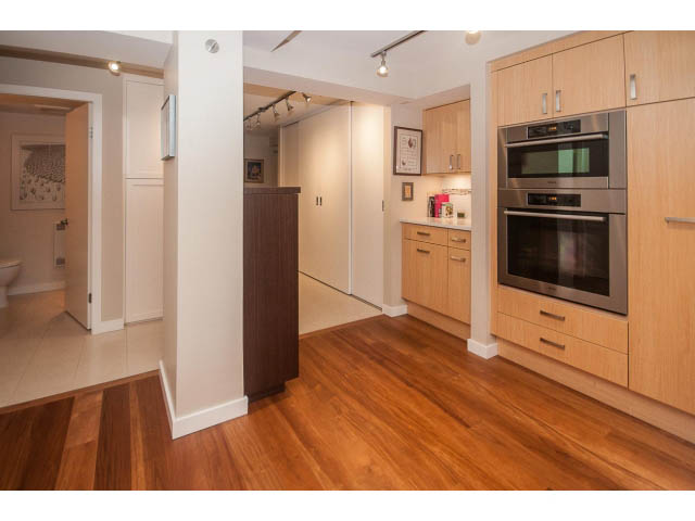 Bright kitchen with wooden floors, stainless steel appliances, and light wood cabinetry. - 108 - 456 Moberly Rd, Vancouver West Side