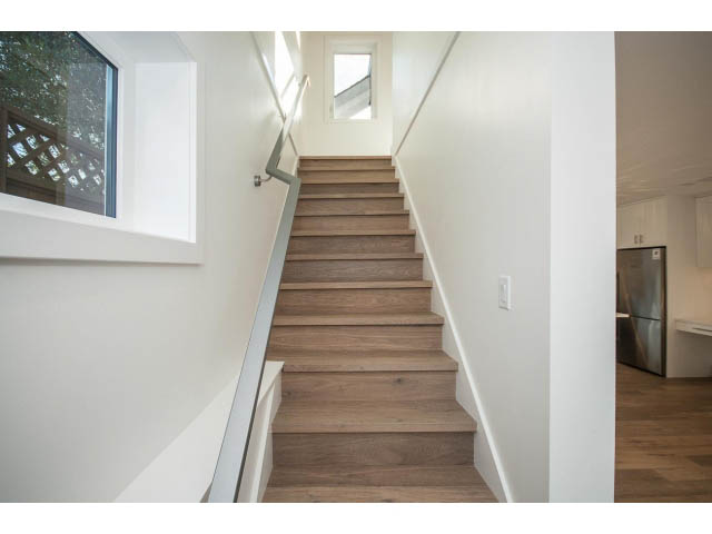 Furnished 1-bedroom house with hardwood stairs and white walls. - 4216 W 10th Ave, Vancouver West Side