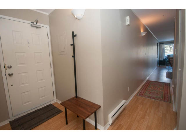 Furnished entryway with hardwood floors and a small table. - 301 - 2288 Laurel St, Vancouver West Side