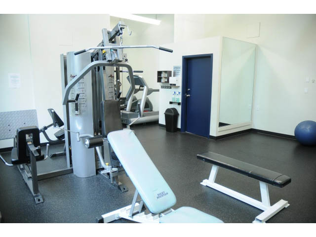 Fitness room with weight machines and a bench. - 307 - 1238 Seymour Street, Vancouver Downtown