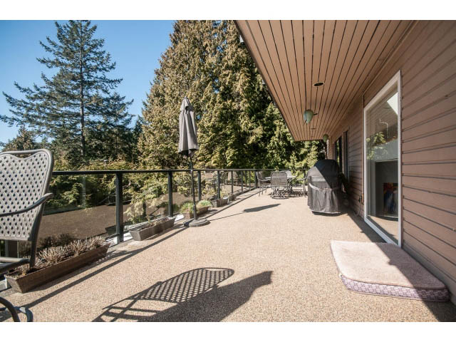 Furnished patio with outdoor furniture and privacy trees. - 3855 Bayridge Ave, West Vancouver