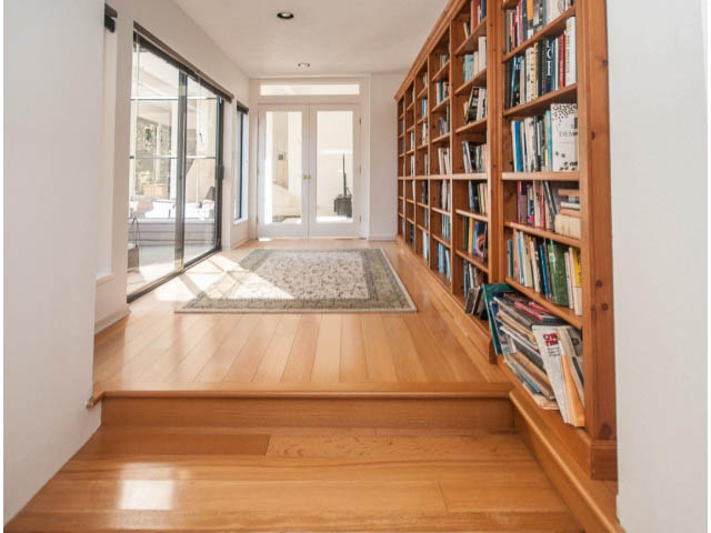 Bright and cozy den with wooden bookshelves and hardwood floors. - 3855 Bayridge Ave, West Vancouver