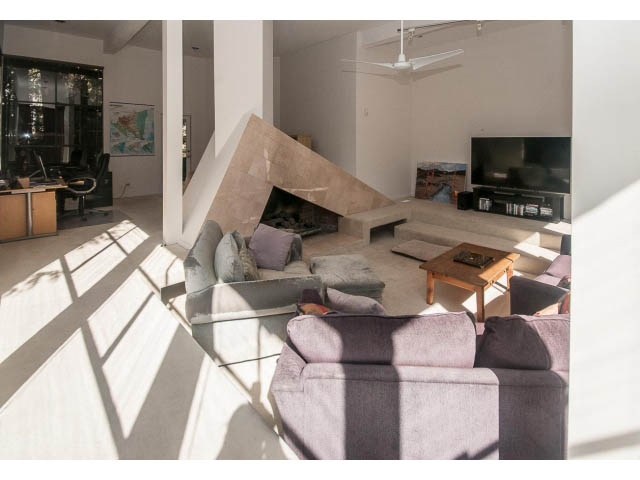 Furnished living room with modern fireplace, large windows, and natural light. - 3855 Bayridge Ave, West Vancouver