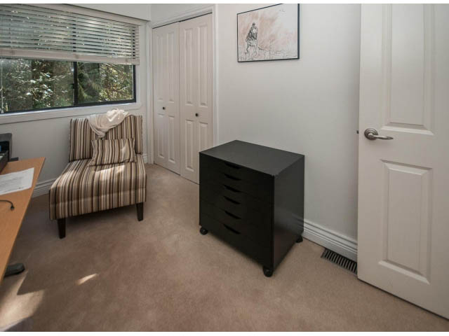 Bright living room with striped armchair, modern furniture, and large window view. - 3855 Bayridge Ave, West Vancouver