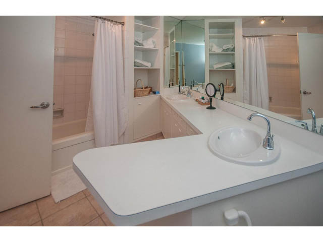 Spacious bathroom with white countertop and large mirror. - 3855 Bayridge Ave, West Vancouver