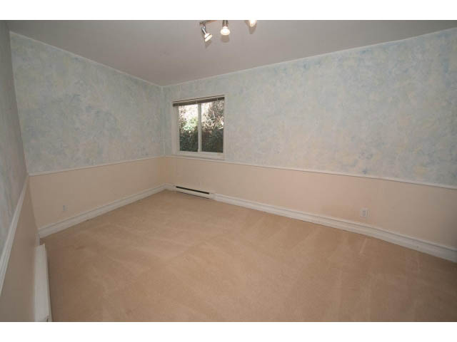 Spacious den with beige carpet and light blue walls, featuring a small window. - 3855 Bayridge Ave, West Vancouver