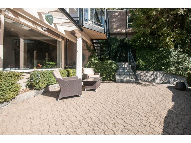 Spacious patio with stone flooring and modern furniture. - 3855 Bayridge Ave, West Vancouver