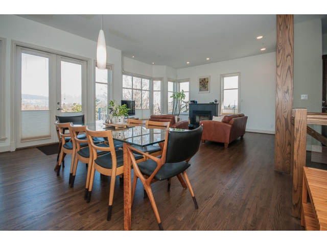 Bright dining and living area with hardwood floors, large windows, and city view. - 3131 Collingwood St, Vancouver West Side
