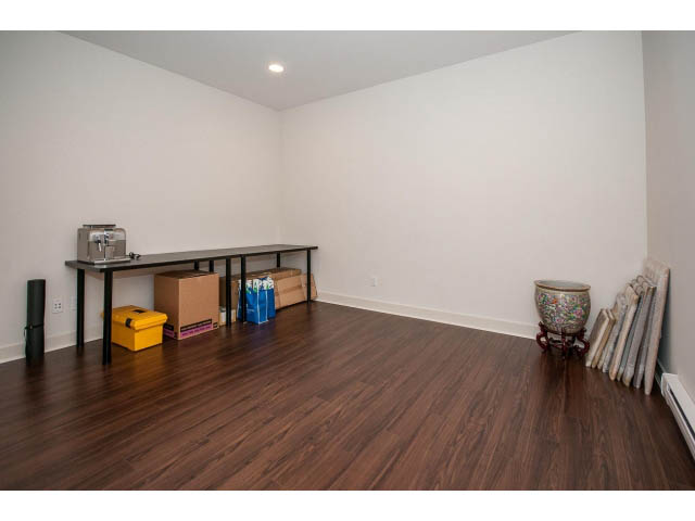 Bright den with hardwood floors and a sewing machine on a table. - 3131 Collingwood St, Vancouver West Side