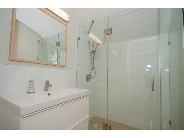 Bathroom with modern glass shower and white countertop. - 3131 Collingwood St, Vancouver West Side
