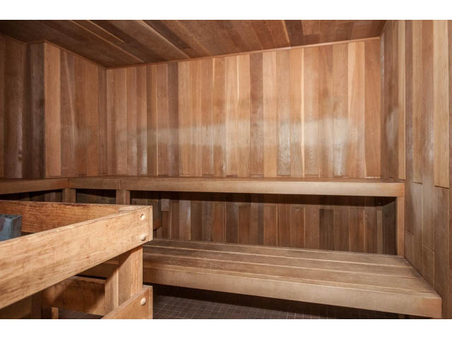 Furnished living room with wooden panel walls and built-in benches. - 1604 - 145 St Georges Ave, North Vancouver