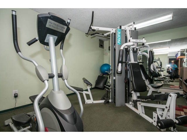 Fitness room with elliptical and weight machines. - 1604 - 145 St Georges Ave, North Vancouver